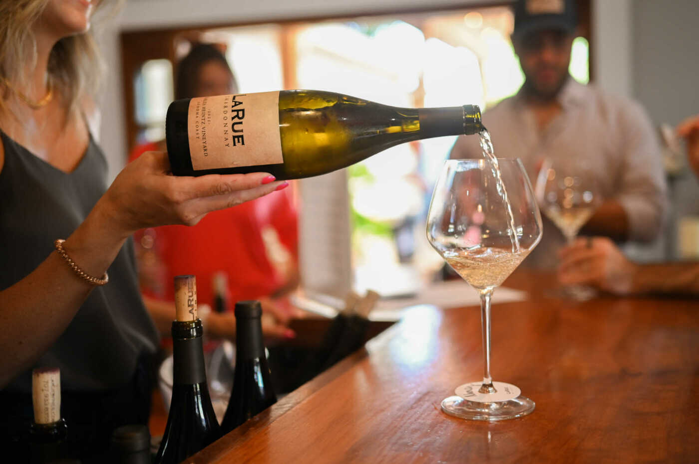 A bottle of wine is being poured into a glass.