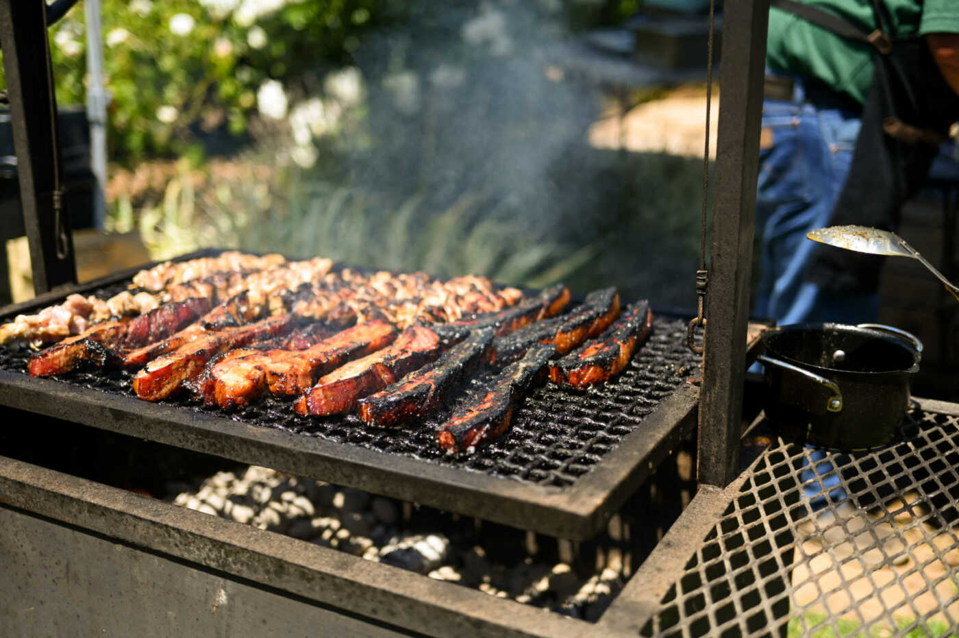 Meat on a grill with smoke.